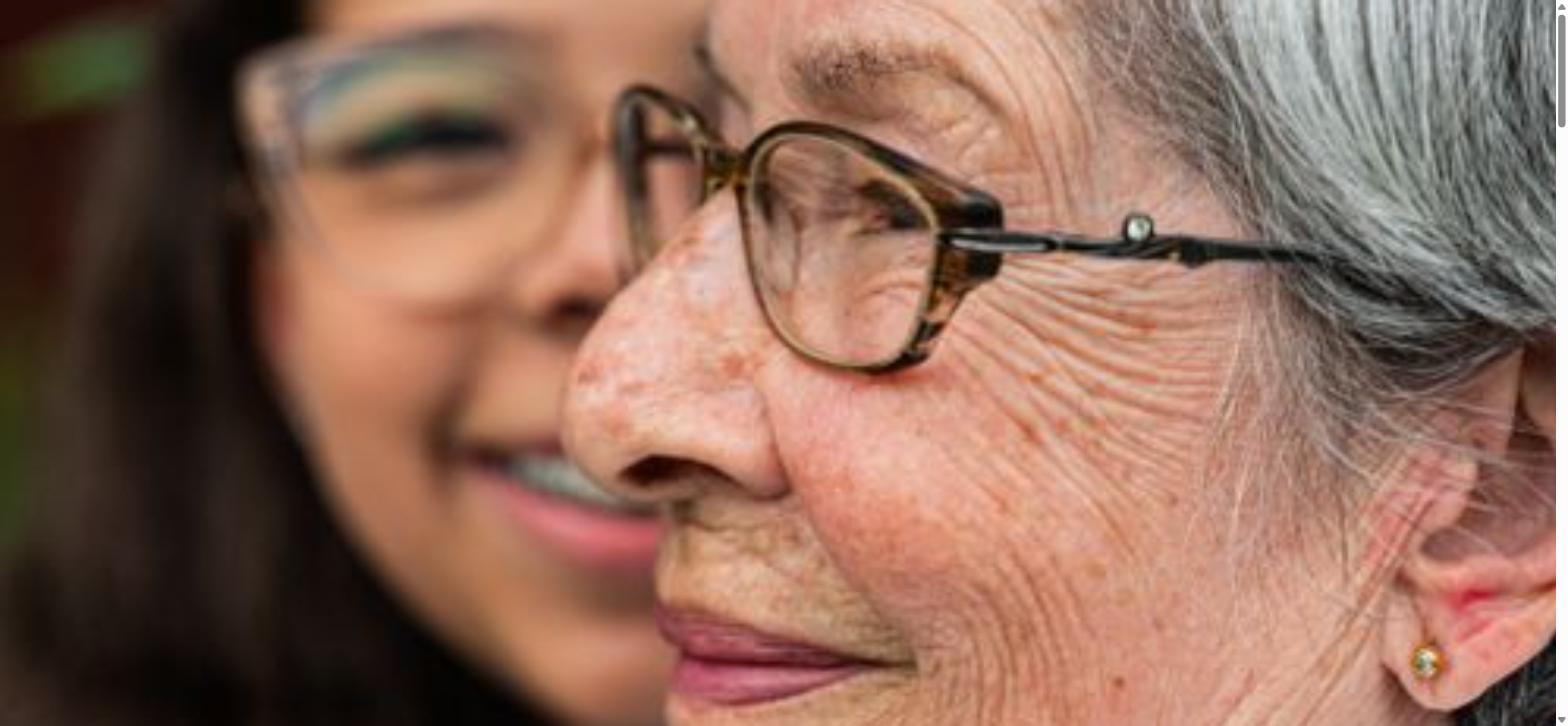 Close, warm profile of a carer and elderly client, symbolising patient dementia care